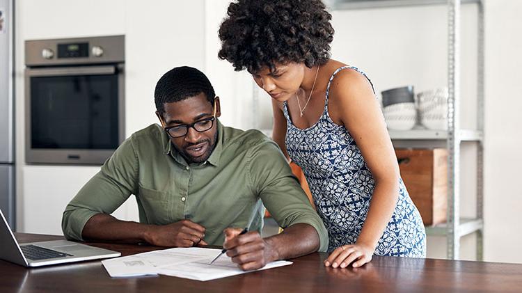 Couple filling out forms together.